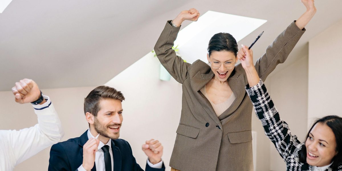 A team celebrates achieving a significant business milestone, reflecting successful ROI realization.