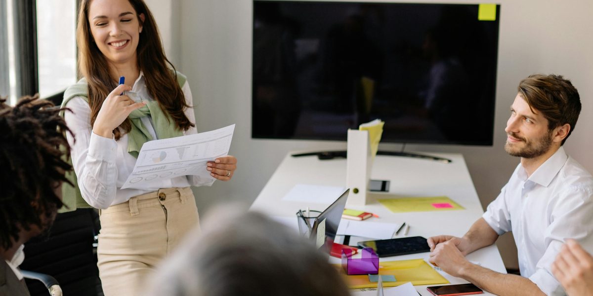 A team collaborating effectively in a meeting, embodying the efficiency gained when AI handles routine tasks like note-taking.