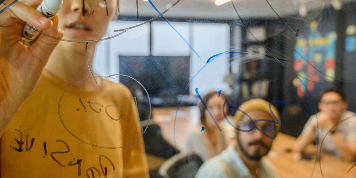 A diverse team actively brainstorming and collaborating on ideas, demonstrating increased engagement from AI-enabled efficiency.