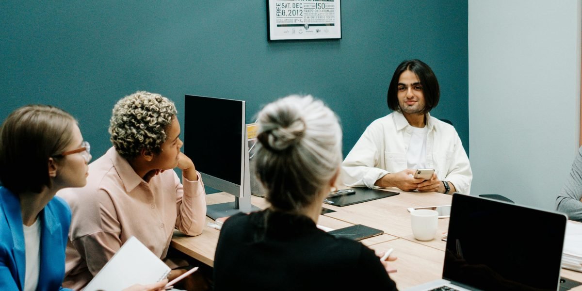 A team of professionals in a meeting, actively discussing and strategizing about AI adoption and vendor selection.