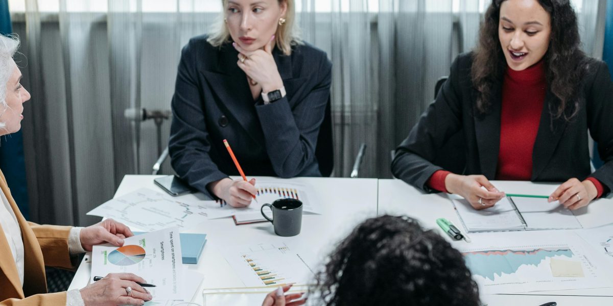 Leaders in a meeting room, thoughtfully discussing complex strategic choices for their business future.