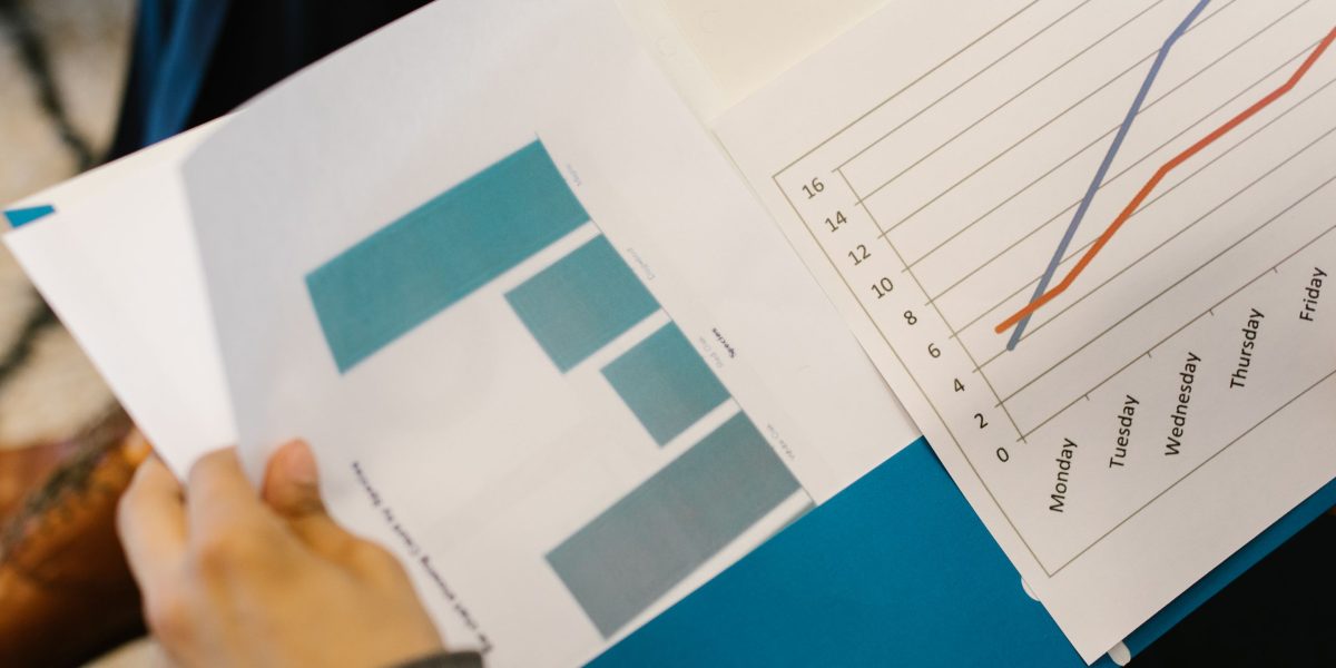 A professional meticulously reviewing financial reports, symbolizing the analysis of AI total cost of ownership and ROI.