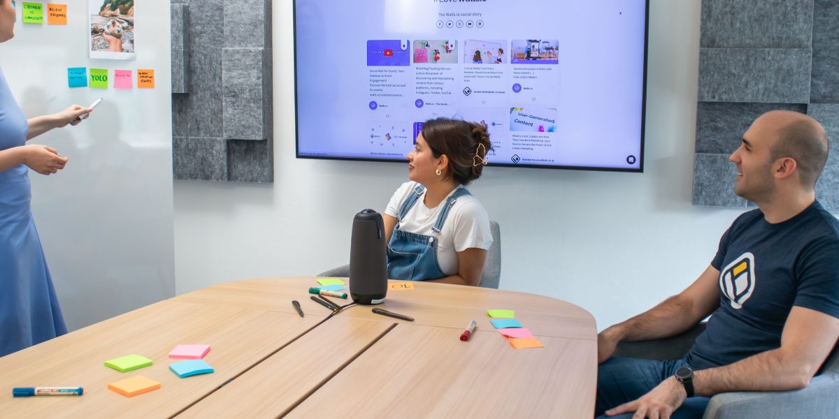 A diverse team actively collaborating and brainstorming ideas on a whiteboard, embodying upskilling and knowledge sharing.
