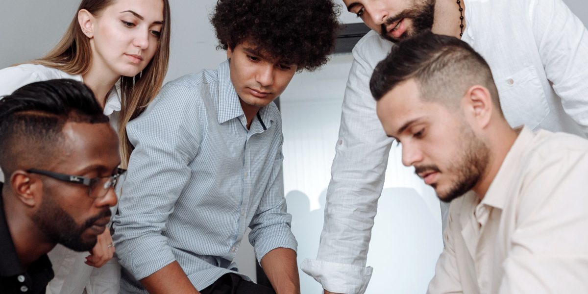 A diverse group of professionals working collaboratively, symbolizing effective team building and upskilling strategies in a modern enterprise.