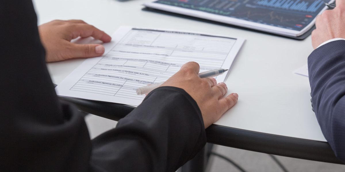 A professional reviewing important documents related to data security and compliance policies.