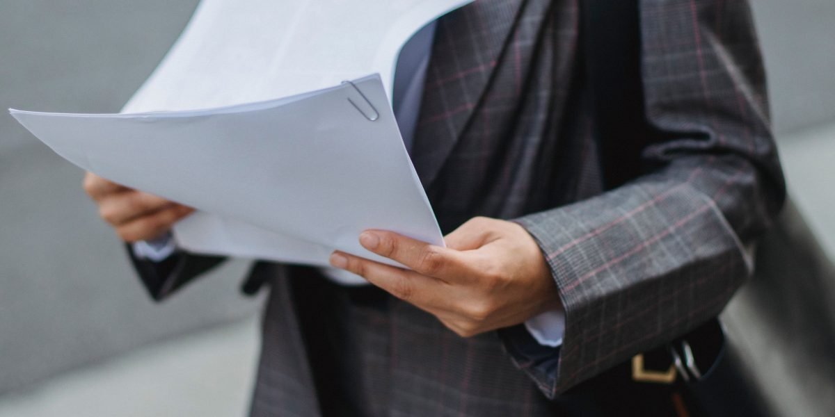 A professional intently reviewing documents, symbolizing the critical importance of adhering to data privacy and ethical regulations with AI.