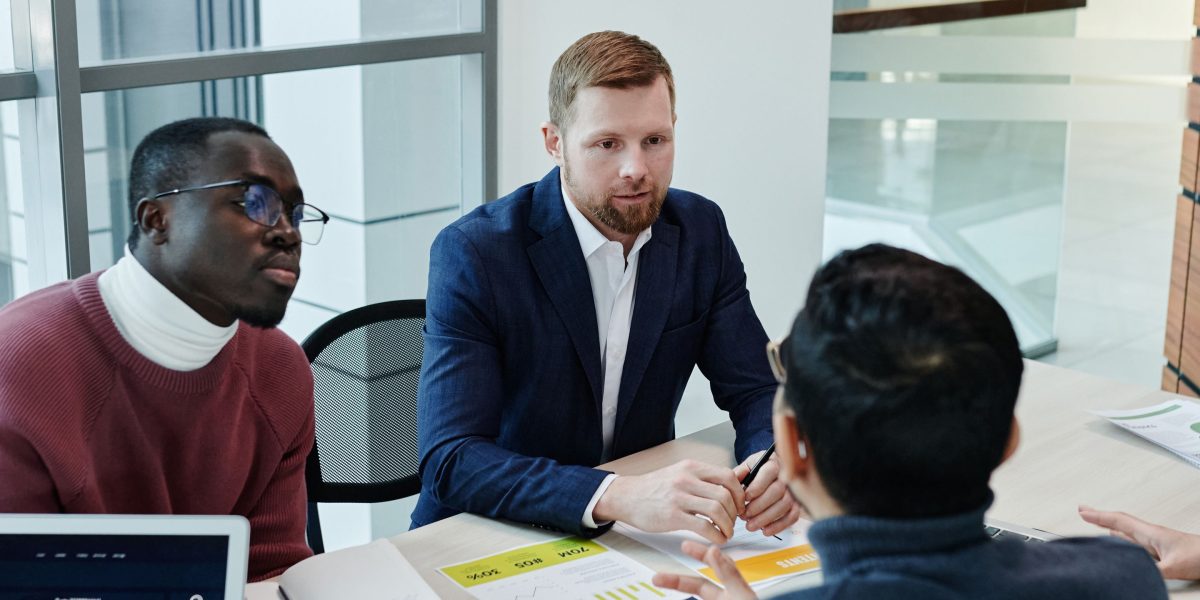 A team collaborates in a meeting, brainstorming solutions to data management challenges.