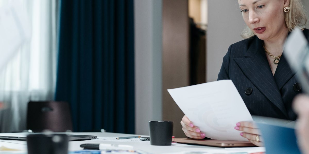 Executives reviewing compliance documents, highlighting the importance of governance and adherence to regulations.