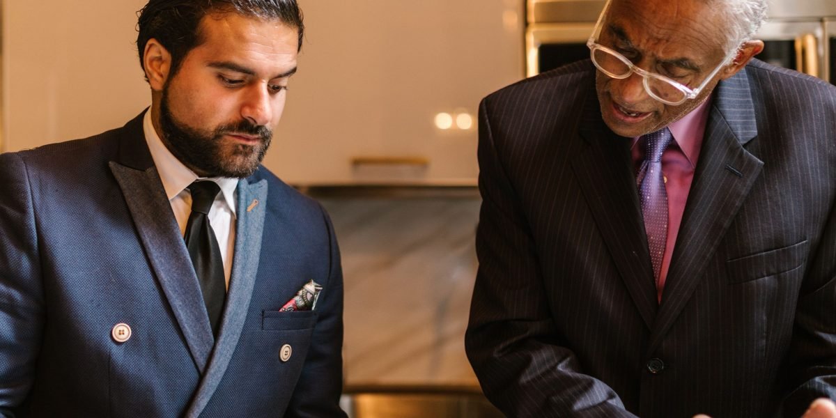 An experienced professional offering guidance and advice to a mentee in a modern office or collaborative setting.