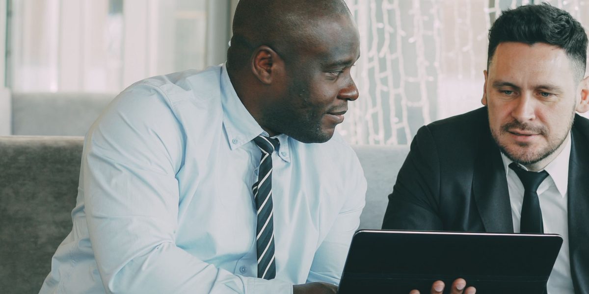 Enterprise leaders in a modern office discussing strategic IT challenges and future technology integration.