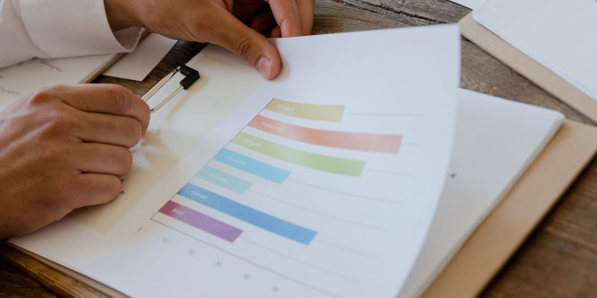 Finance and HR professionals review budgeting documents and ROI projections for talent development programs.