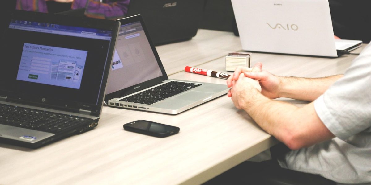 A business team diligently reviews and discusses contract terms to mitigate risks.