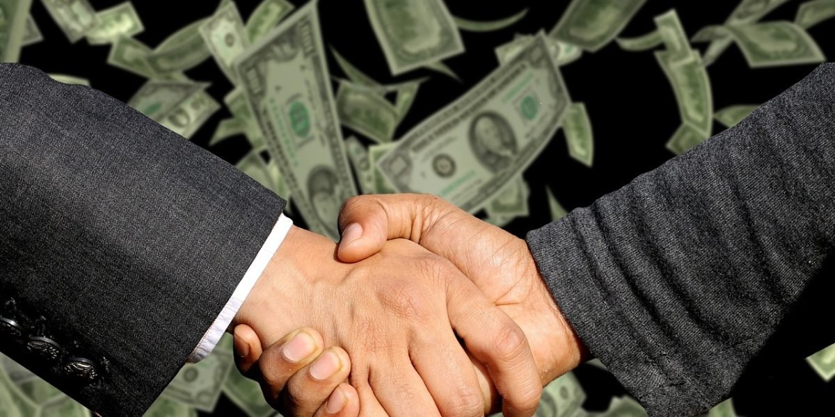 Professionals finalize a successful business agreement with a confident handshake.