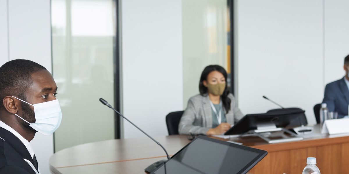 Professionals engaged in a serious discussion about cybersecurity, compliance, and managing vendor risks.