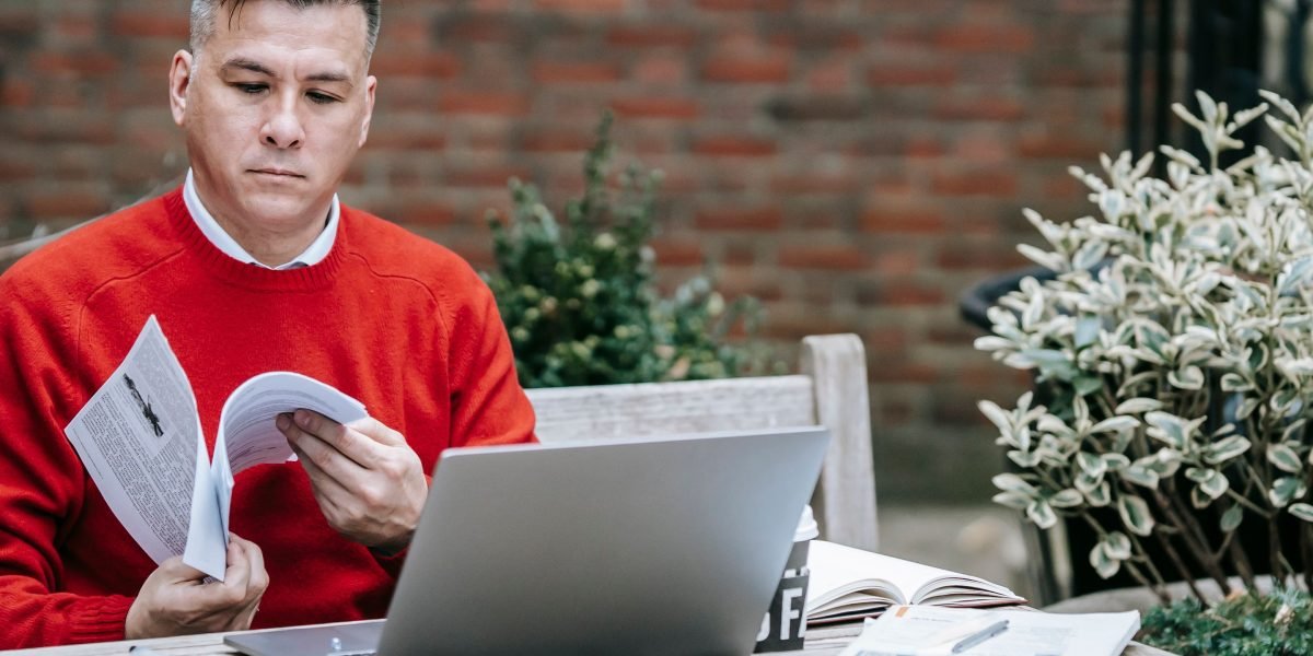 A person intently reviewing a strategic roadmap or project plan, symbolizing planning for future IT trends and business growth.