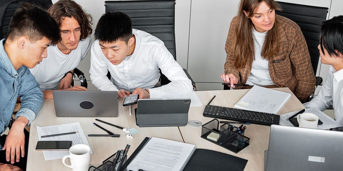 A team actively collaborating on new project ideas, benefiting from tools that simplify development and free up time.