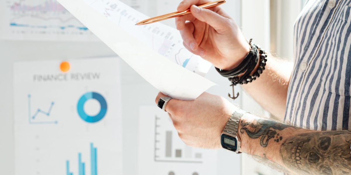 A person engaged in analyzing financial data, reflecting the importance of cost optimization in cloud computing.