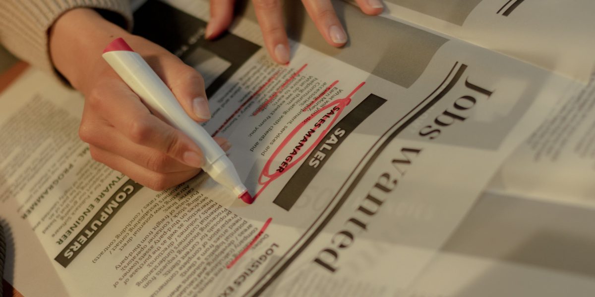 A hiring manager carefully reviewing resumes or candidate applications, making critical decisions about new talent.