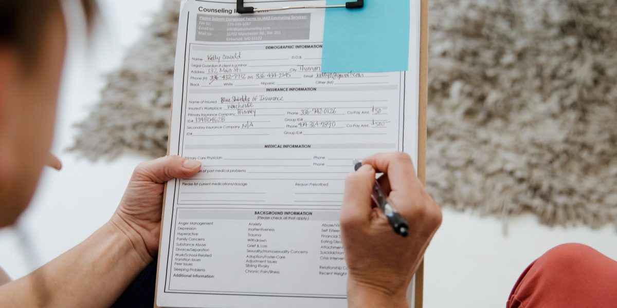 A person receiving constructive feedback on documents, essential for continuous improvement in adaptive processes.