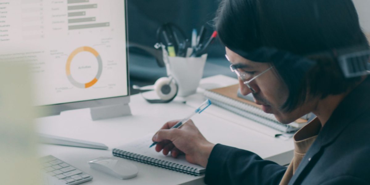 A professional meticulously reviews compliance reports, emphasizing the importance of security and regulatory adherence for enterprises.