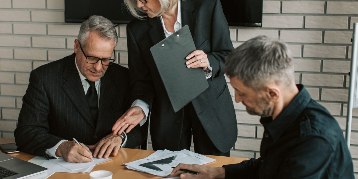 Company leaders deliberate the strategic decision to build AI in-house, weighing unique needs against potential risks.