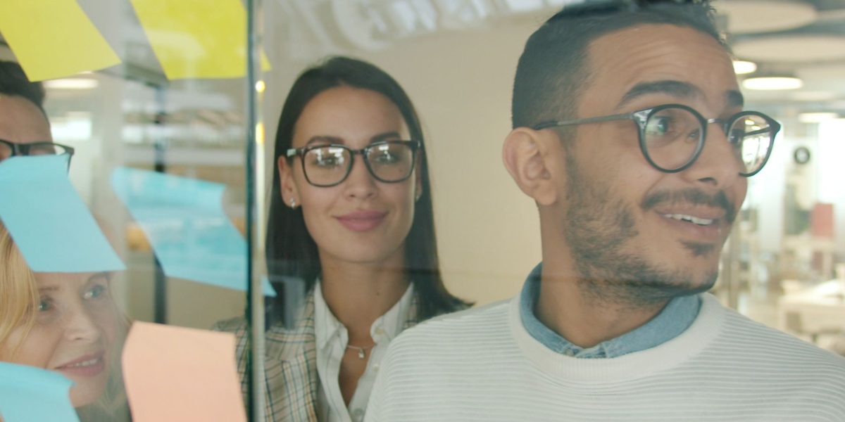 A collaborative team works together to conceptualize innovative AI features, aiming for product differentiation.
