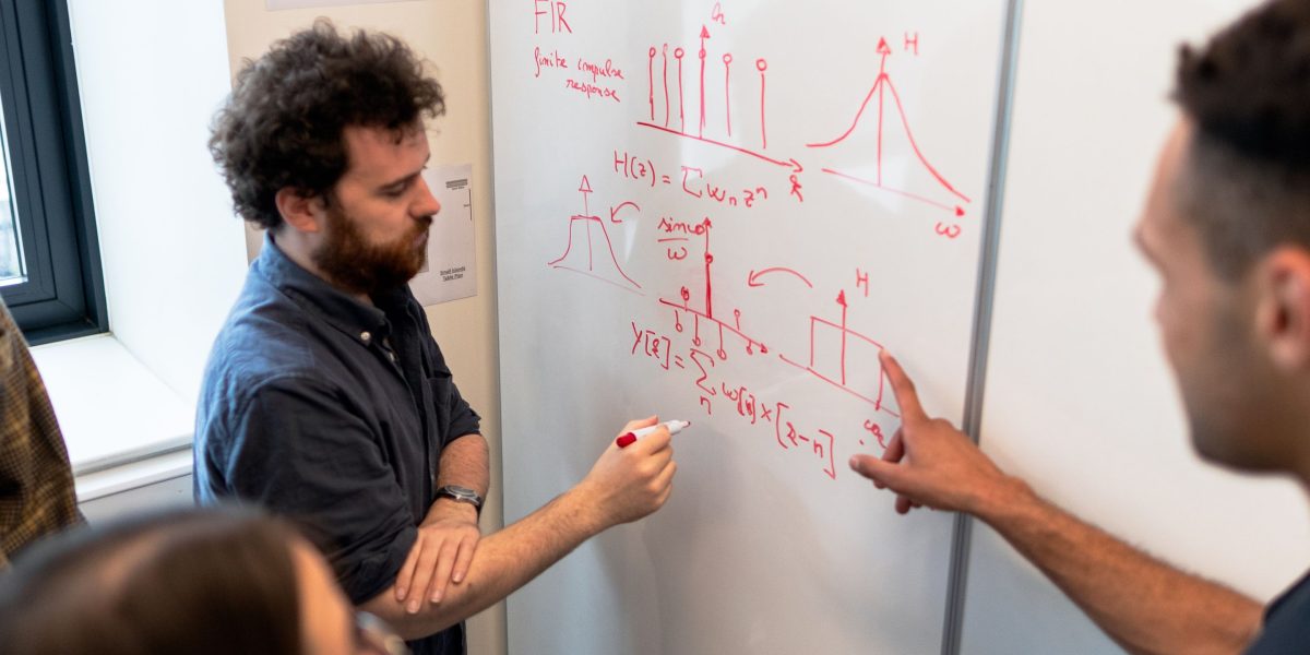 Professionals collaborating to analyze and prepare data, ensuring quality for AI model training.
