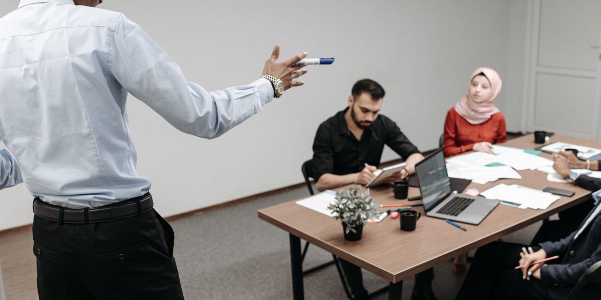 A diverse team collaborating around a whiteboard, symbolizing cross-functional efforts in AI development.