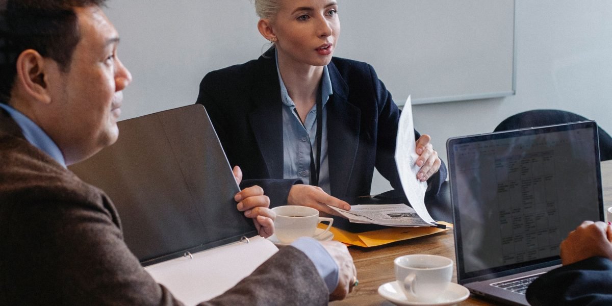 A group of professionals discussing career paths or hiring strategies in a collaborative office environment.