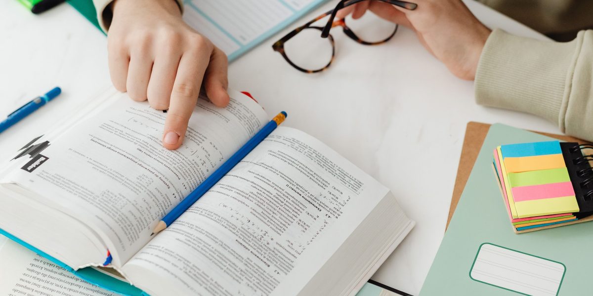 A student deeply engrossed in studying, reflecting the dedication required for foundational computer engineering subjects.